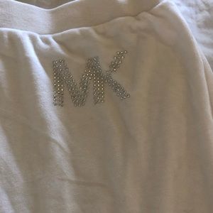 Michael Koers an white wide legged pants